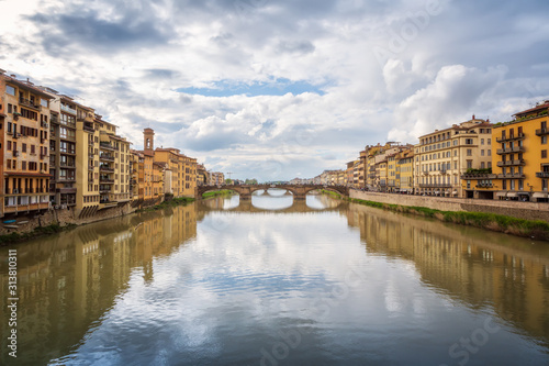 Panoramic day view of Ponte Santa Trinita (Holy Trinity Bridge) over Arno River in Florence, Italy.