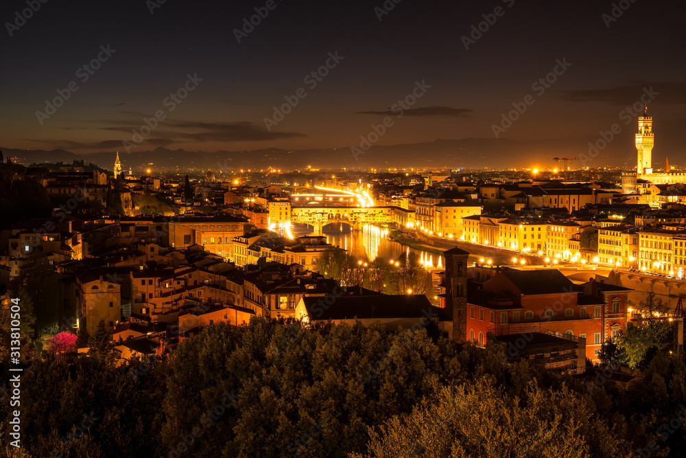 Amazing panoramic night view of Florence city, Italy with the river Arno, Ponte Vecchio and Palazzo Vecchio.
