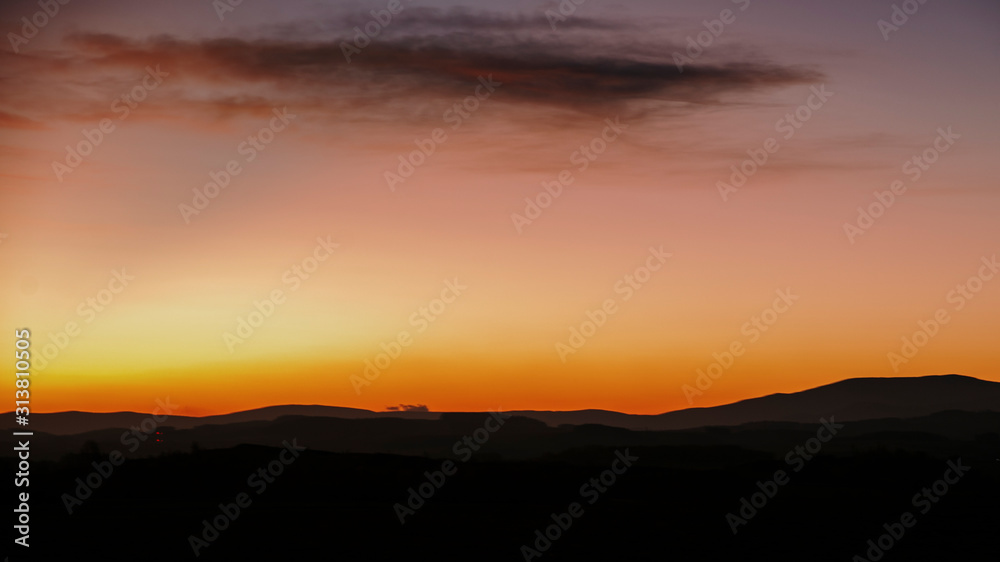 sunrise on the meadow with hills in background sunrise on the meadow with hills in background