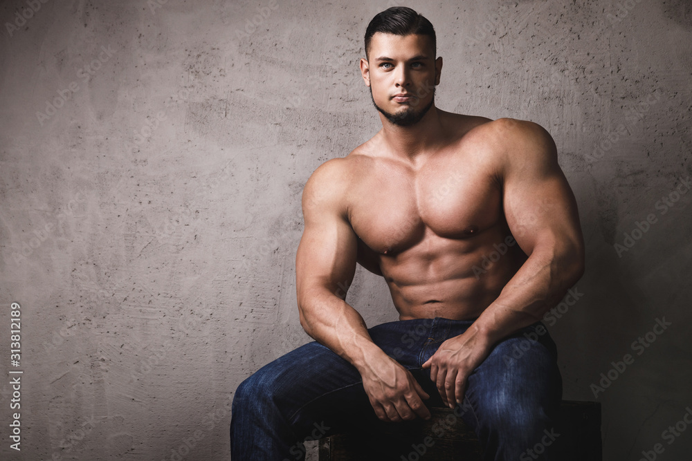 Massive bodybuilder posing beside the concrete wall Stock Photo | Adobe ...