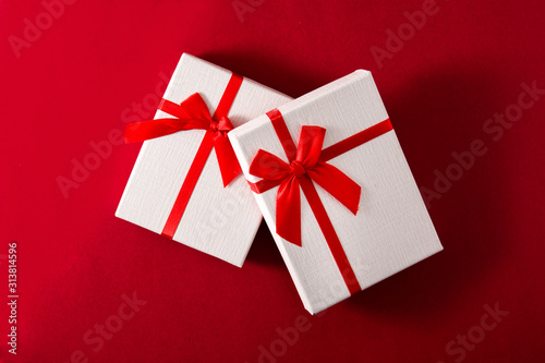Assorted white gift boxes on red background. Top view