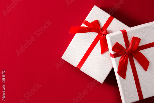 Assorted white gift boxes on red background. Top view. Copy space