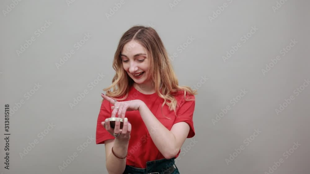 Serious young caucasian woman in fashion red shirt having compas, looking at camera isolated on white background in studio. People sincere emotions, lifestyle concept. Serious young caucasian woman in fashion red shirt having compas, looking at camera isolated on white background in studio. People sincere emotions, lifestyle concept.