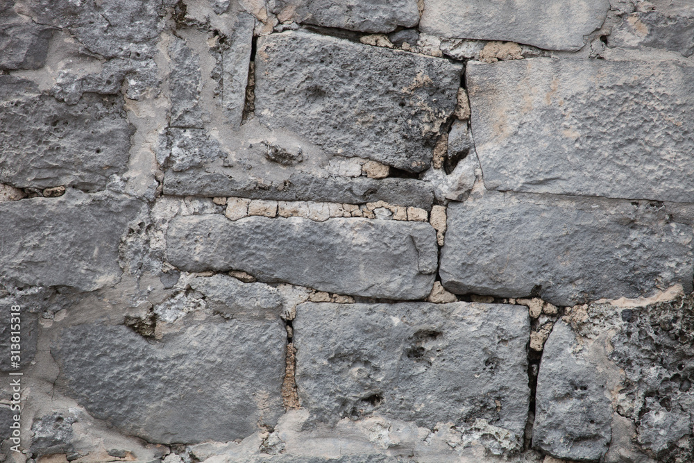 Rough weathered ancient mayan stone wall surface texture close up Rough weathered ancient mayan stone wall surface texture close up