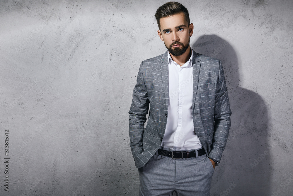 Handsome bearded man wearing gray checkered suit