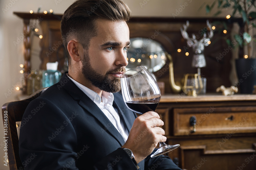 Handsome bearded man with a glass of red wine