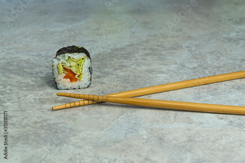 closeup sushi rolls with chopsticks on the table. Japanese food.