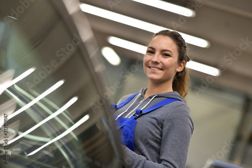 Portrait of apprentice standing in mechanics workshop