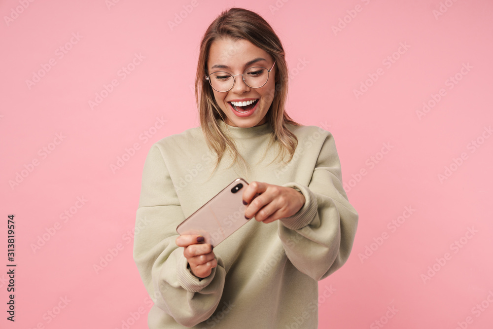 Portrait of nice smiling woman playing video game on cellphone Portrait of nice smiling woman playing video game on cellphone