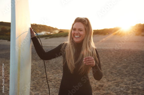 Photography Woman Wearing Wetsuit Holding Surfboard Enjoying Surfing Staycation On Beach As
