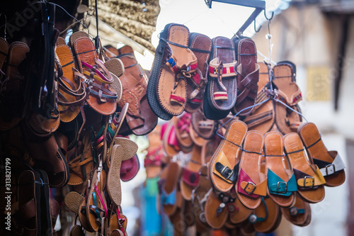 Flip flop shoes outside the shop of a merchant in the souk of the medina of Fes in Morocco