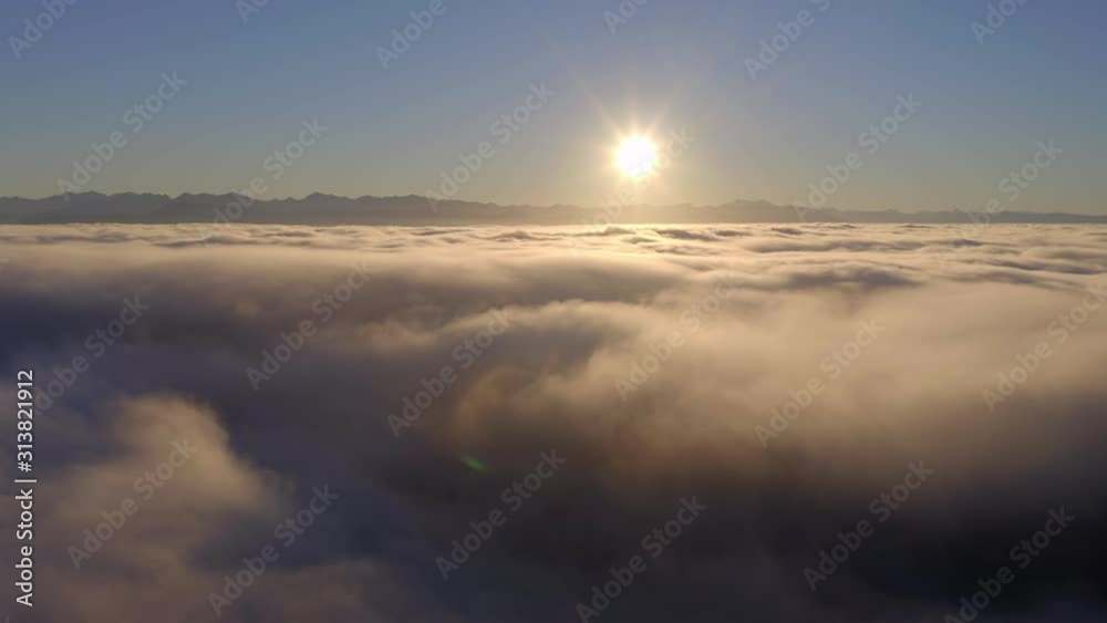 flying low over the clouds during a beautiful sunrise flying low over the clouds during a beautiful sunrise