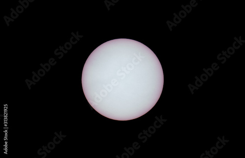 Detailed view of sun with sunspots and black sky