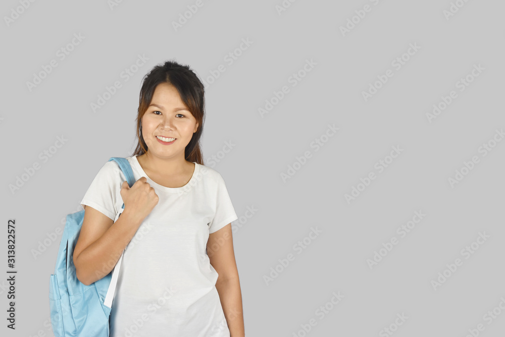 asian beautiful young student smiling with backpack on gray background. asian beautiful young student smiling with backpack on gray background.