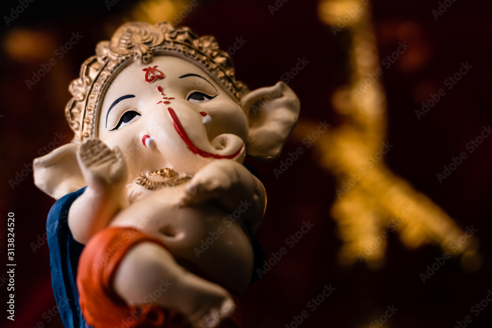low angle body shot of ganesha statue blessing with the hand. hinduism and religious concept. low angle body shot of ganesha statue blessing with the hand. hinduism and religious concept.
