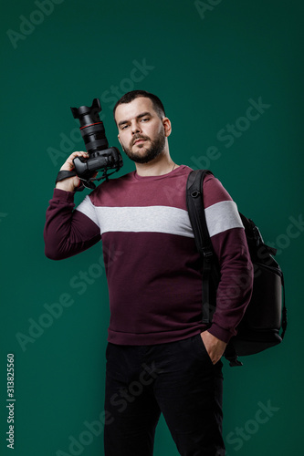 bearded man photographer takes images with professional digital photo camera