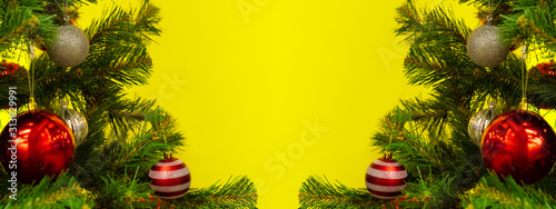 New Year and Christmas background with copy spase. Christmas branches frame on yellow.