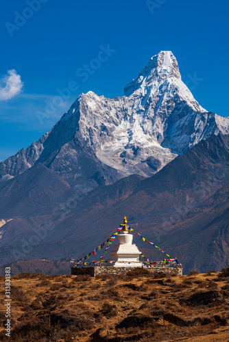 Buddhist stupa on the background of the Himalayan mountains. Nepal. Himalayas. Panorama of the Himalayan mountains. Trekking in the Himalayas.