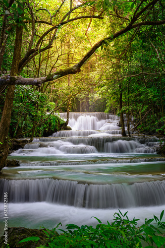 Fototapeta Naklejka Na Ścianę i Meble -  A beautiful waterfall deep in the tropical forest steep mountain adventure in the rainforest.