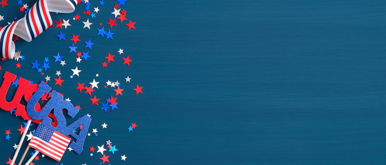 Presidents Day USA concept. Festive flat lay style composition with sign USA, grosgrain ribbon in American flag colors and confetti stars. Wide banner template for Independence day or Memorial Day.