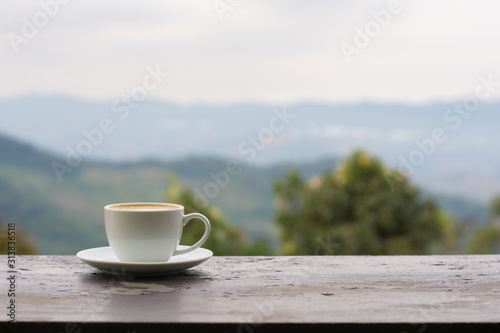 Coffee espresso on wood table nature background in garden,warm tone