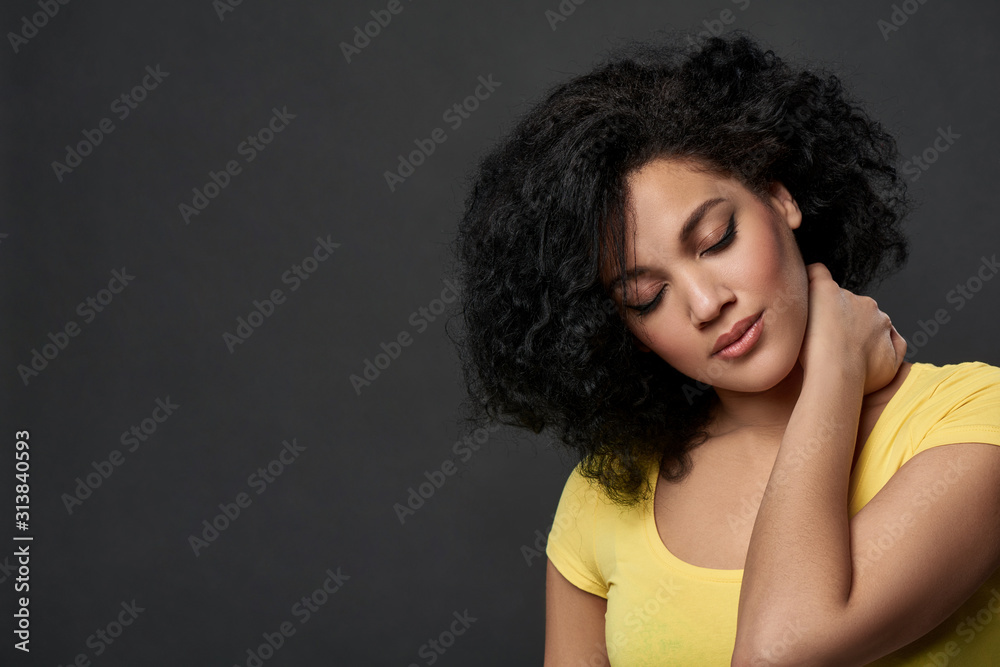 Tired woman touching her neck Tired woman touching her neck