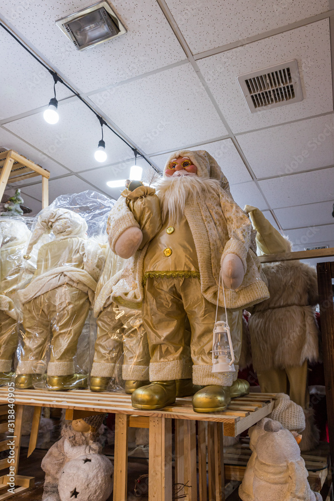 Fototapeta premium Numerous dolls - Santa Clauses stand on shelves at the Christmas market in Bethlehem in Palestine