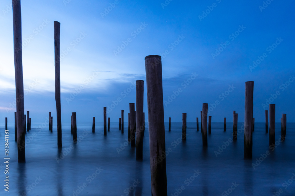 Poles at the sea during blue hour