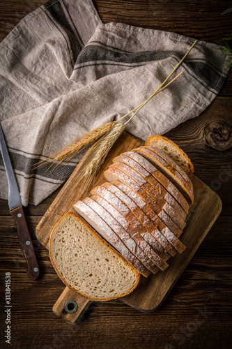 Obraz na plátně Sliced loaf of bread on a chopping board.