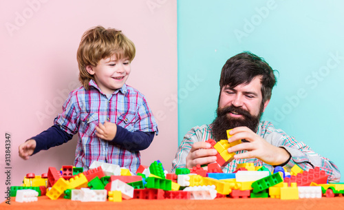 Love Still Keeps Us Together. small boy with dad playing together. happy family leisure. child development. building home with colorful constructor. father and son play game. Good idea