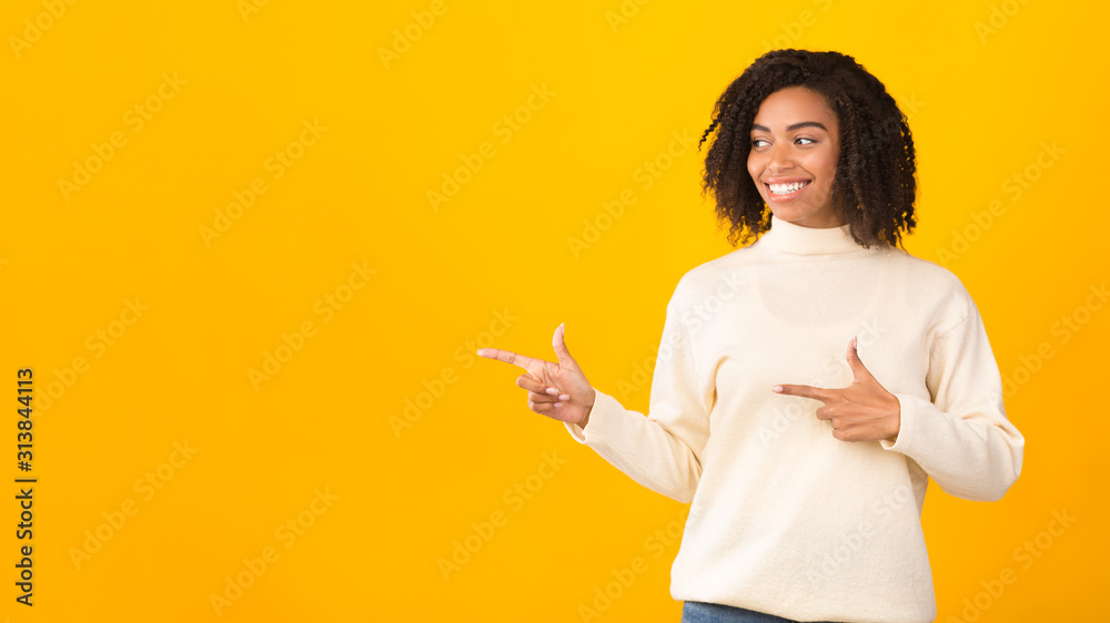 Smiling black girl pointing fingers at free space Smiling black girl pointing fingers at free space