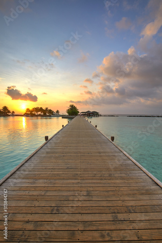 Fototapeta Naklejka Na Ścianę i Meble -  Footbridge of Paradise Island (Lankanfinolhu) at sunset, Maldives