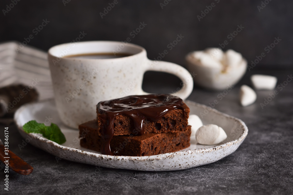 Chocolate brownie with coffee and marshmallows on a concrete background. Chocolate brownie with coffee and marshmallows on a concrete background.