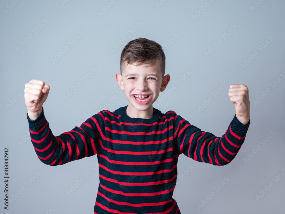 young boy showing a winning expression