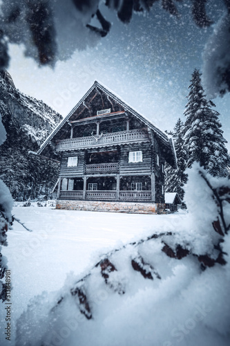 wooden house in winter forest in austria