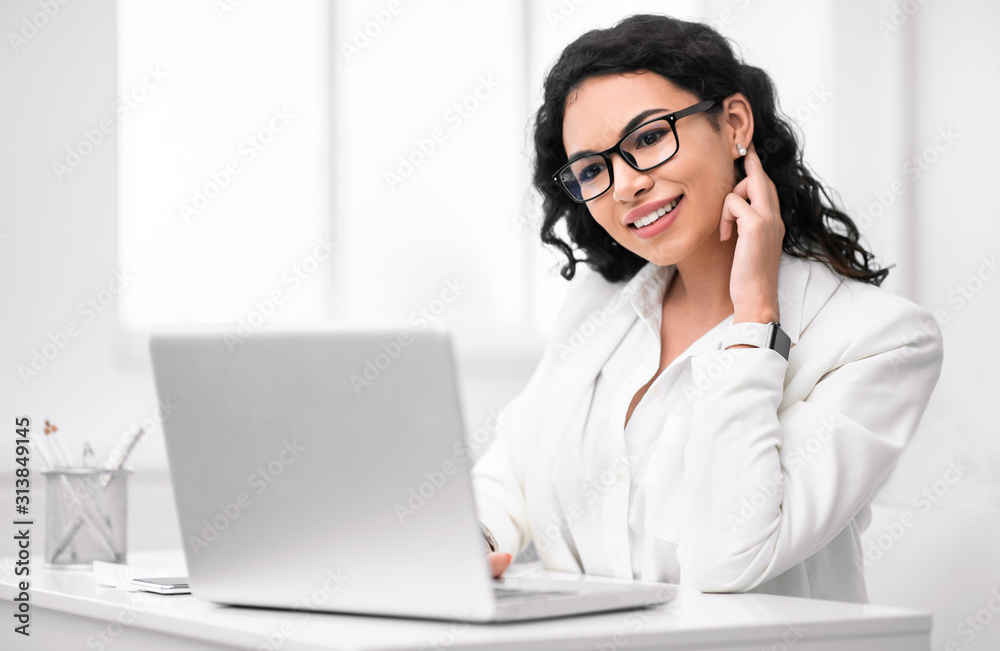 Satisfied hispanic girl manager typing on keyboard Satisfied hispanic girl manager typing on keyboard