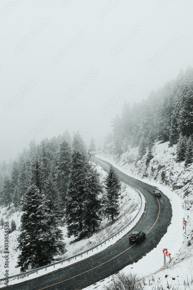 Winter road in the forest. Aerial view the a winding mountain road at .turkey Winter road in the forest. Aerial view the a winding mountain road at .turkey