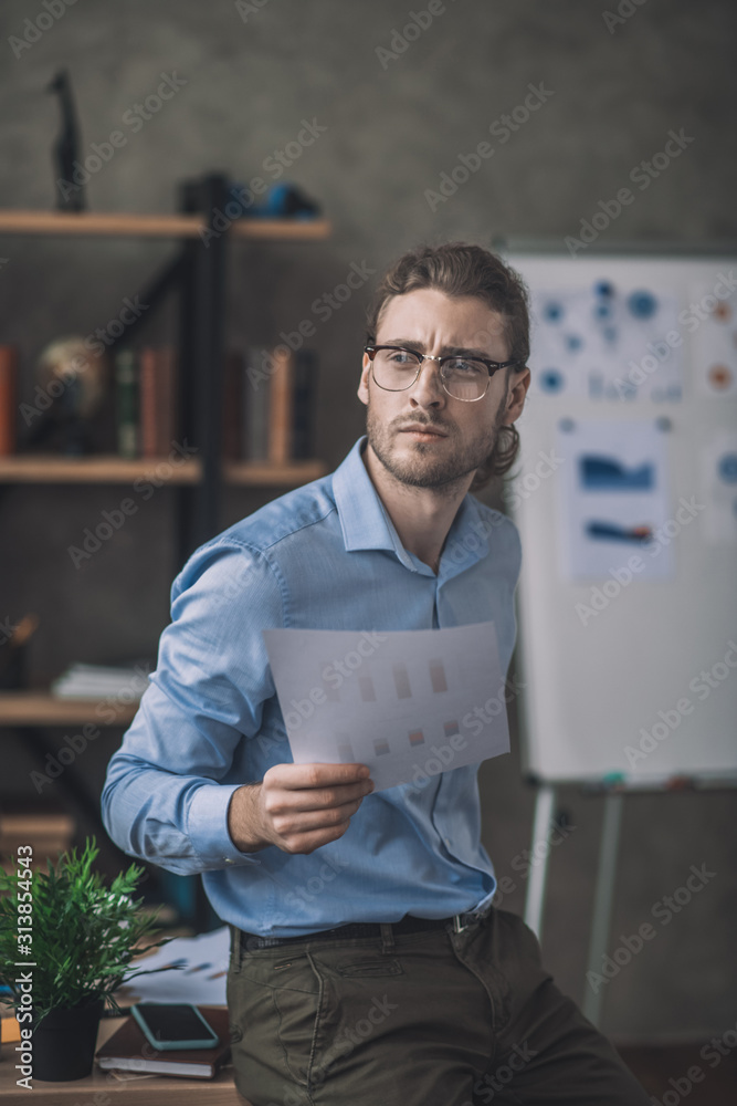 Young bearded man in blue shirt having an idea