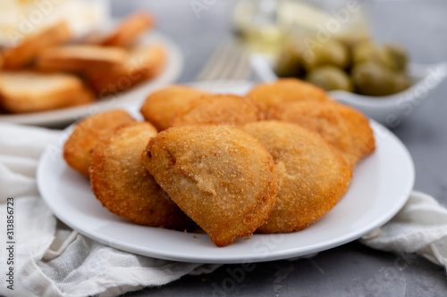 typical portuguese snack with meat rissois de carne on ceramic background