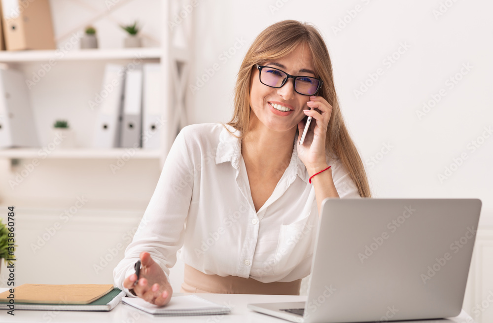 Joyful Office Girl Talking On Cellphone Sitting At Workdesk Indoor Joyful Office Girl Talking On Cellphone Sitting At Workdesk Indoor