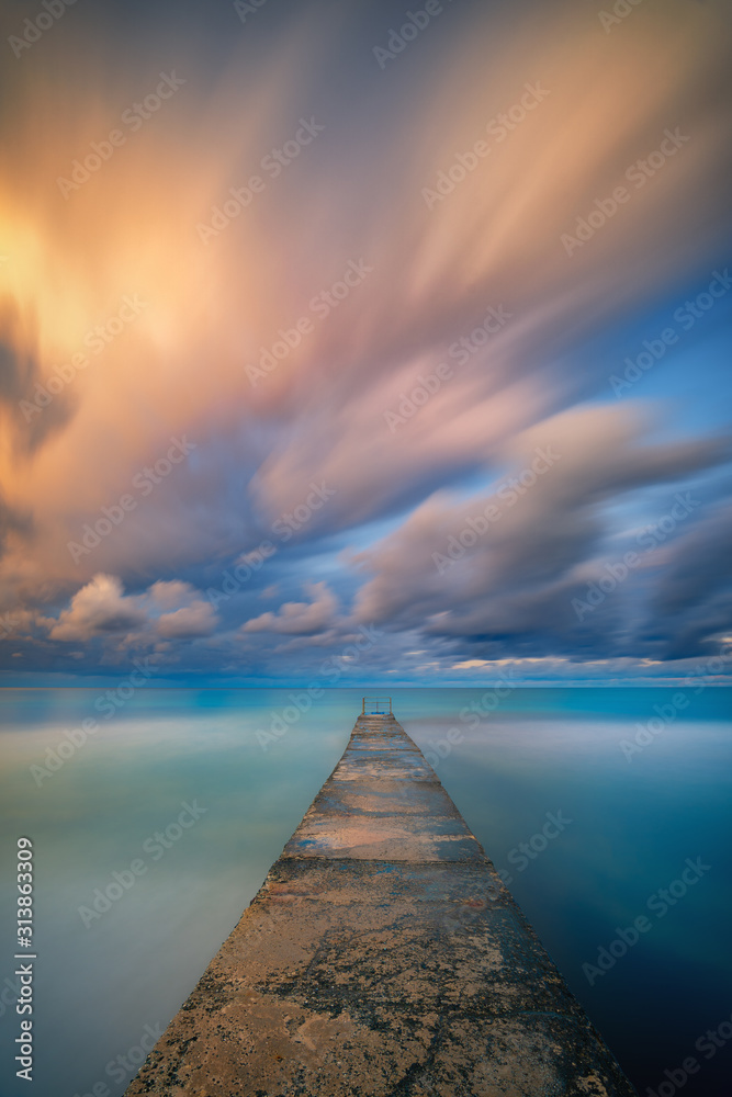 Obraz premium Long exposure seascape fine art photograph of pier on a sunrise in Paphos, Cyprus