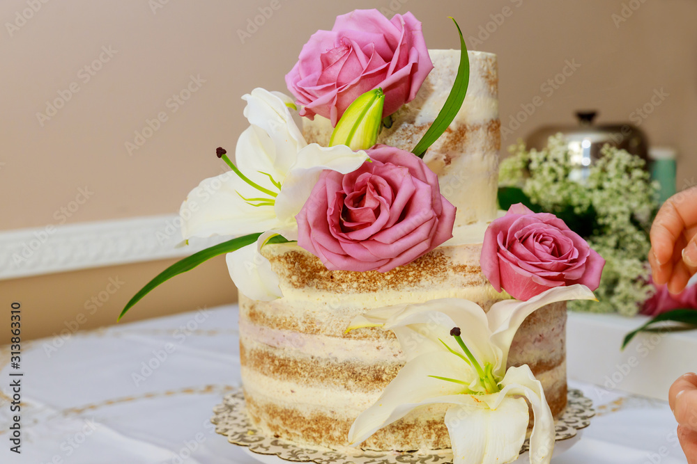 Wedding naked cake decorated with purple roses. Wedding naked cake decorated with purple roses.