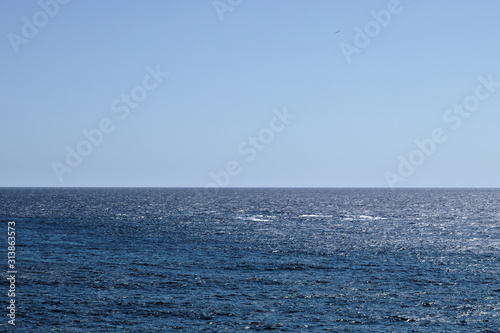Horizon with blue sky over blue water