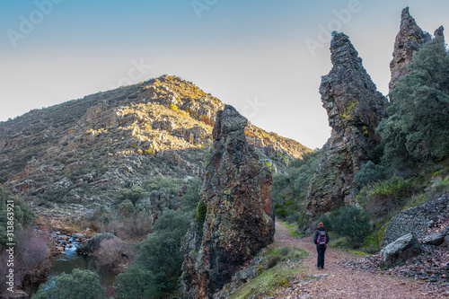 Hiker at the Three quarzite towers site at National Park of Cabaneros, Spain photo