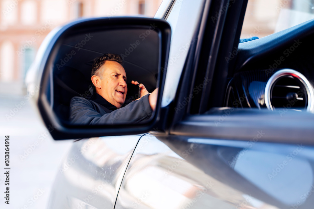 senior person using smartphone in a camper van