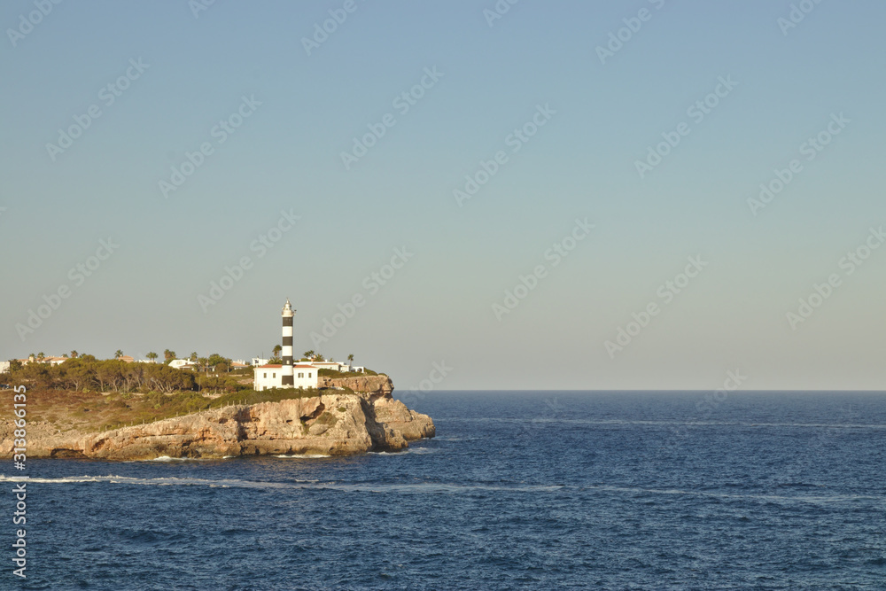 Lighthouse at the ocean in the evening sun