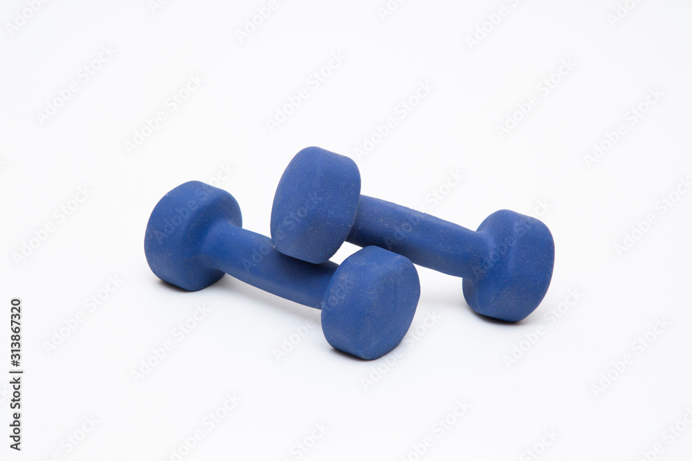 Blue dumbbells on a white background. The concept of sports.