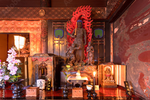 Canvas Print Wood sculpture of buddhist deity Fudou Myoo which is the king of immutable light in the Tendai Buddhism Gokokuin temple of Tokyo