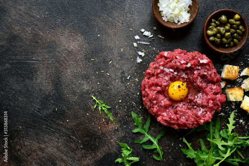 Beef tartare - traditional dish of french cuisine.Top view. photo