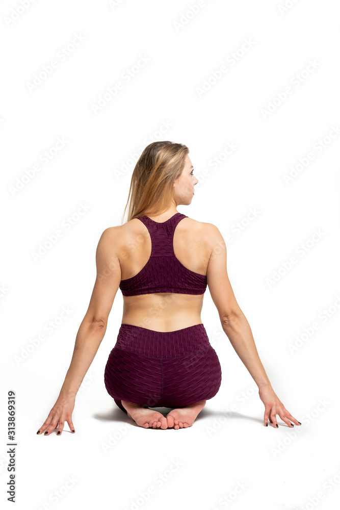 blonde girl doing gymnastic stretching dressed in sportswear with white background blonde girl doing gymnastic stretching dressed in sportswear with white background